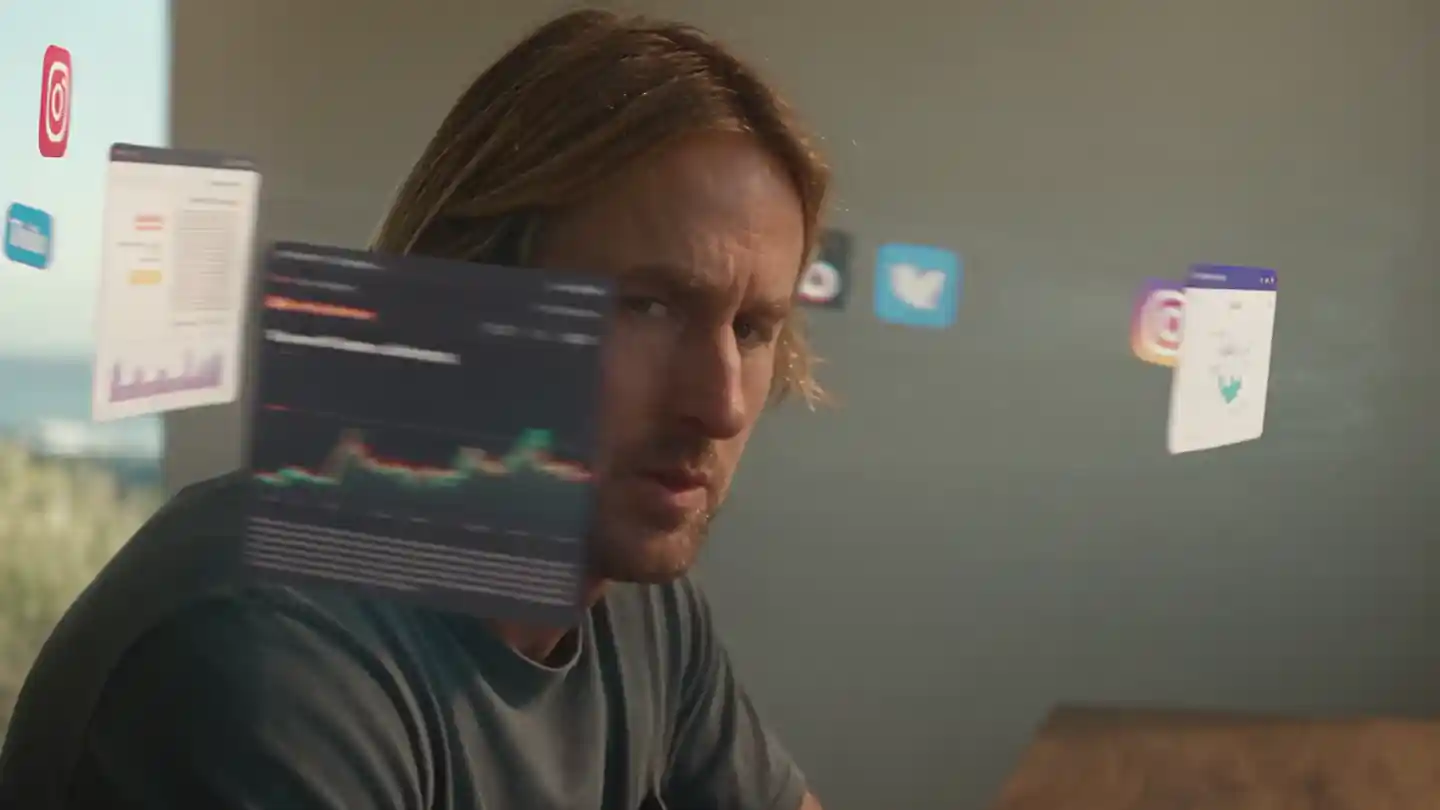 A trader surrounded by financial news, YouTube and social media in his coastal office.